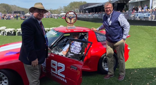 The No. 92 Mazda RX-7. Seated in the car is Walt Berchak, who restored the car along with IMSA's Mark Raffauf (left) and John Doonan (right).