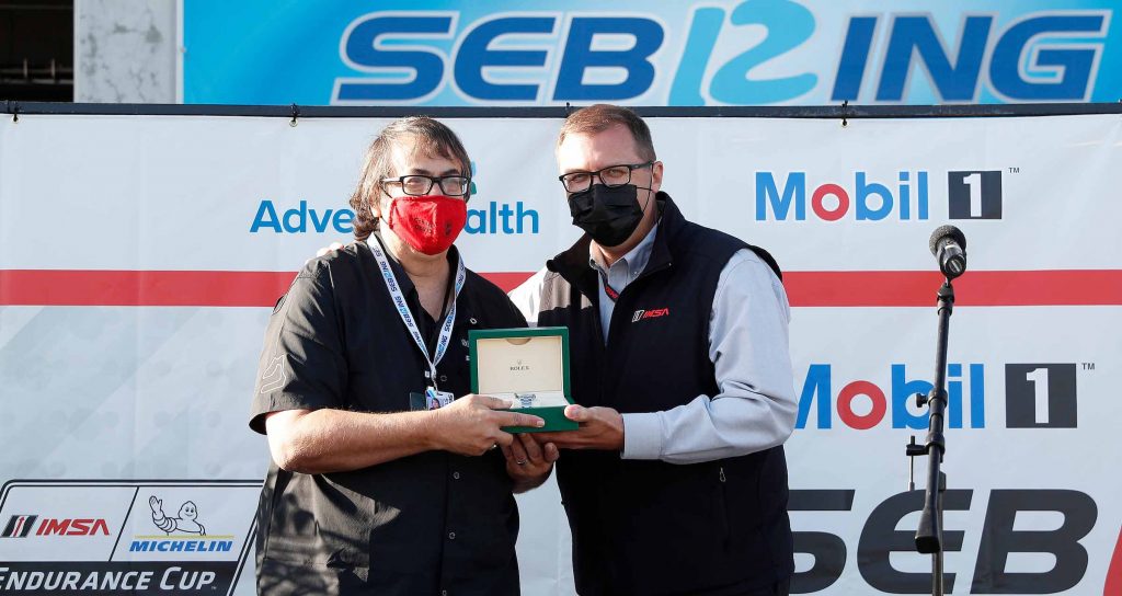 Retiring Sebring PR Ken Breslauer receives a Rolex Daytona watch from John Doonan