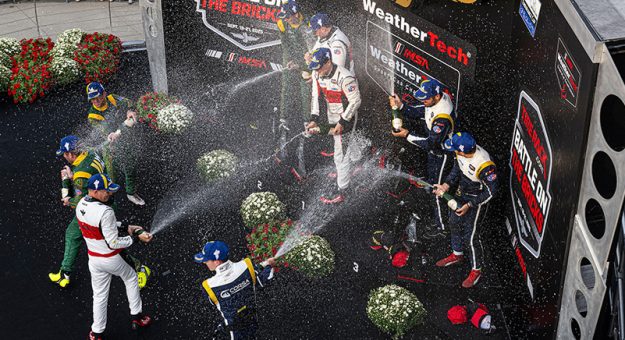 Second place, #120: Wright Motorsports, Porsche 911 GT3 R (992), GTD: Adam Adelson, Elliott Skeer, Tom Sargent; winners #70: Inception Racing, Ferrari 296 GT3, GTD: Brendan Iribe, Frederik Schandorff, Ollie Millroy; and third place, #34: Conquest Racing, Ferrari 296 GT3, GTD: Manny Franco, Daniel Serra, Ben Tuck, spray champagne on the GTD victory podium